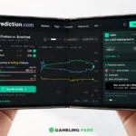 Smartphone screen displaying a dark stock-trading dashboard from Prediction.com with charts and a green Buy button, held by two hands in landscape mode.